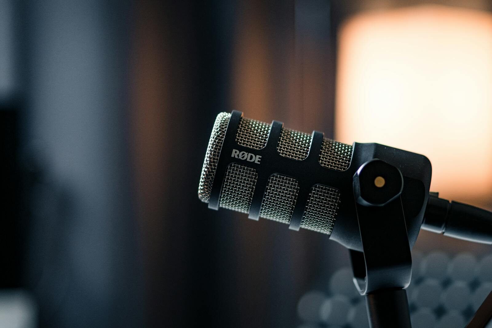 Close-up of a Rode microphone in a studio, emphasizing professional audio equipment.
